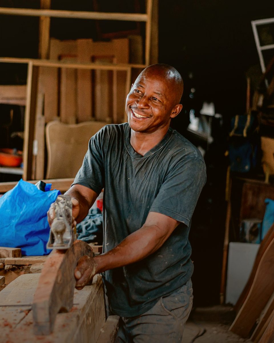Craftsman working wood in a workshop, representing the Ownership phase